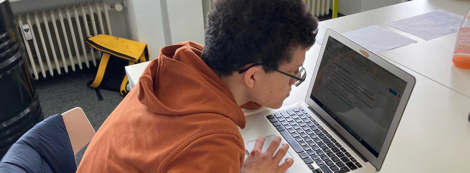german student reading the training content on the screen
